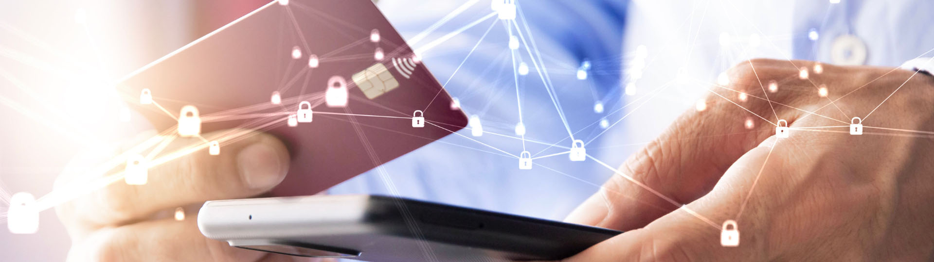 A businessman holding a cellphone and debit card.