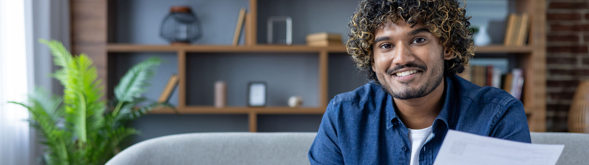 Man sitting on a couch and smiling.
