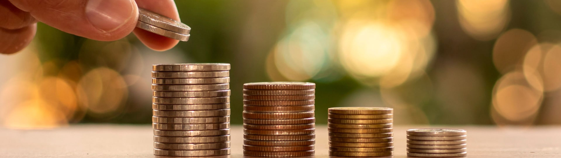 Stack of coins being added to.