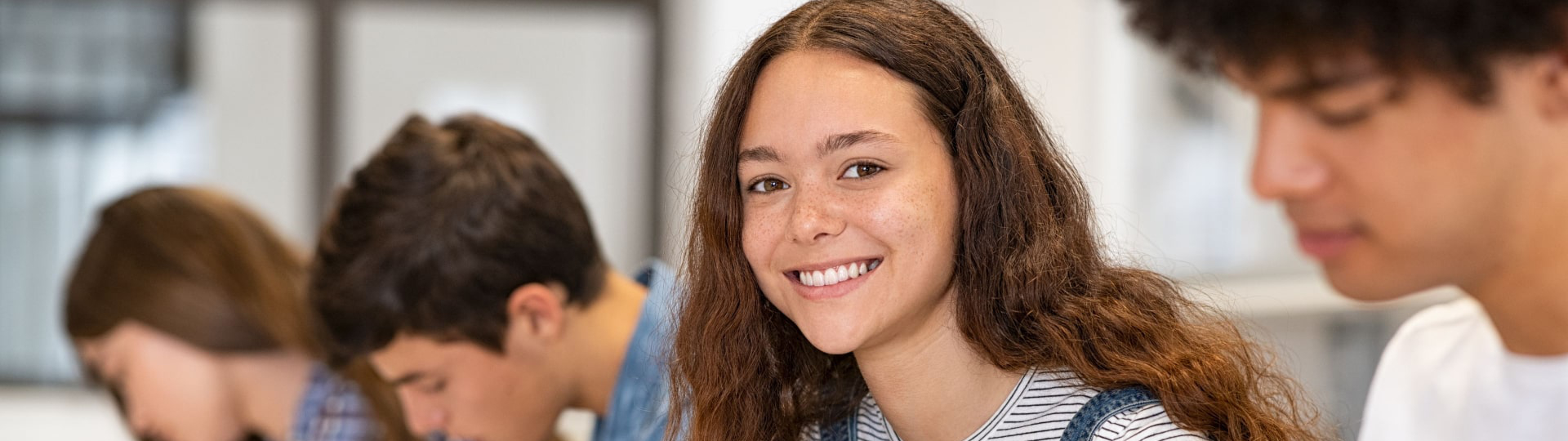 Smiling woman working on a class assignment.
